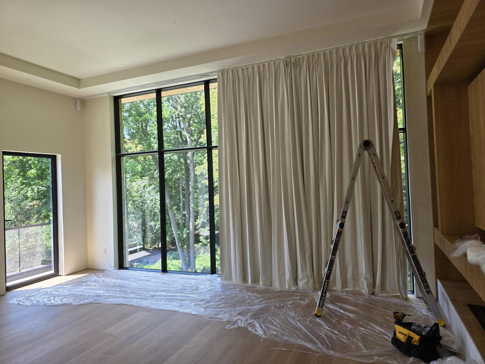 Bright addition interior with tall black-framed windows