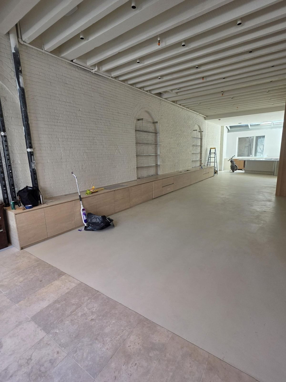 Brick loft mid-build with millwork going in under the arches