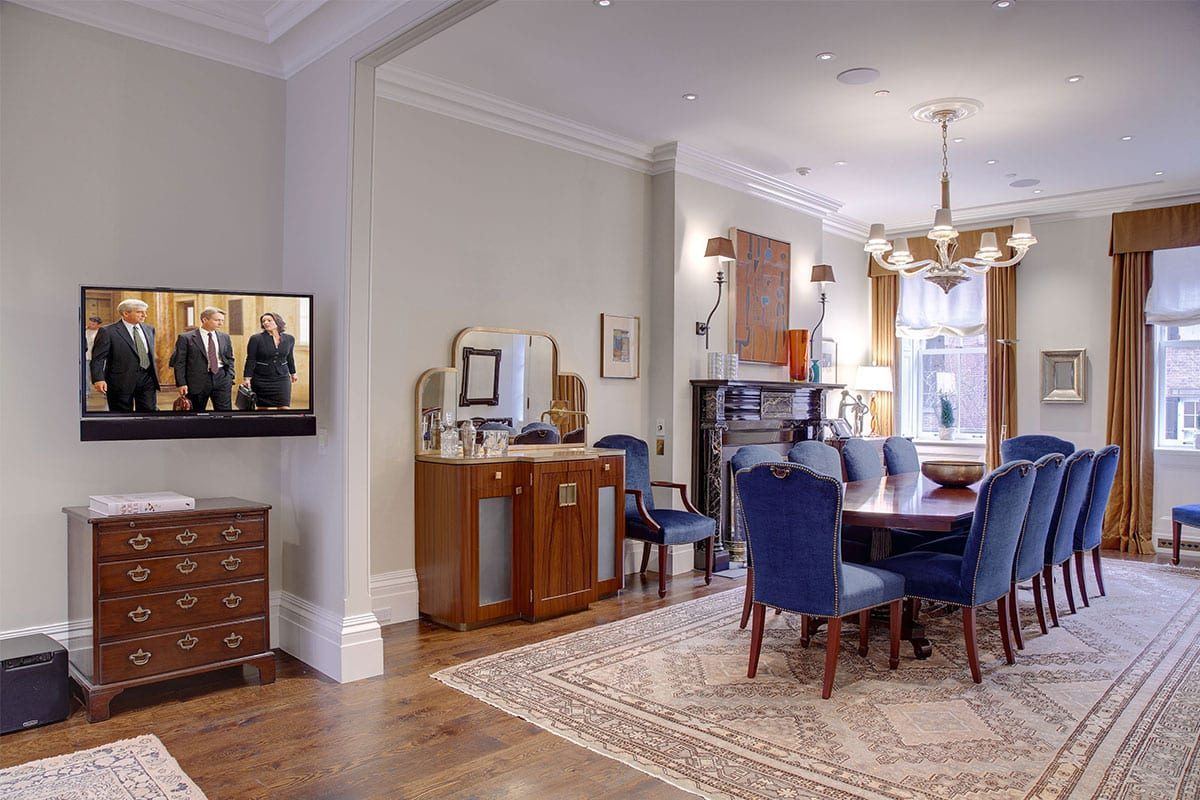 Formal dining room with flush-mounted TV and ceiling speakers