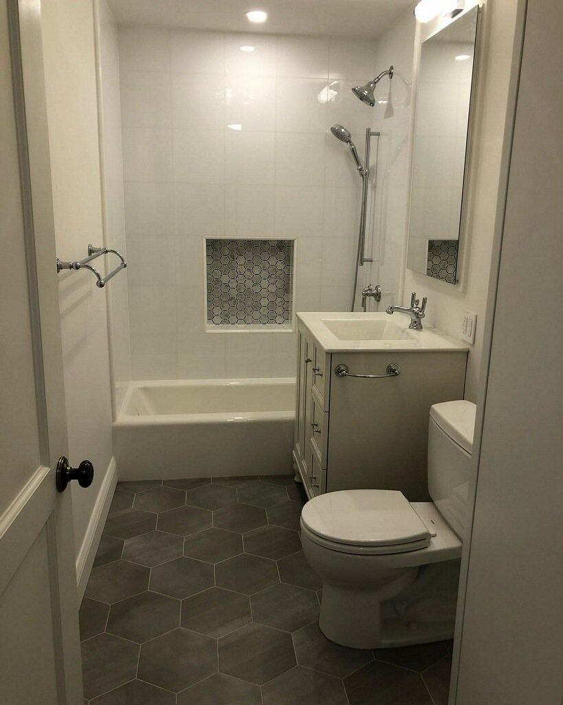 Full bath with tub, hex mosaic niche and vanity