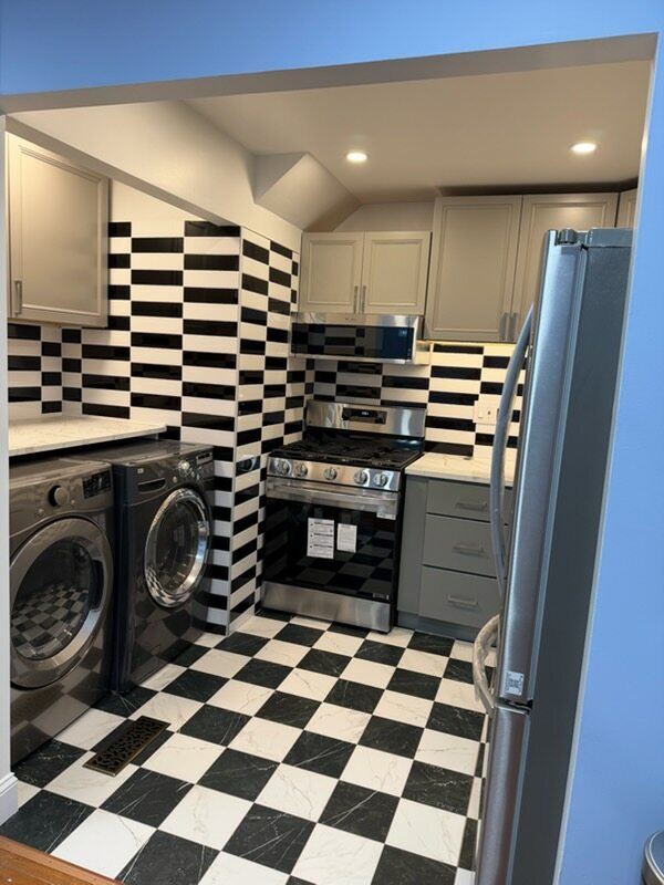 Kitchen and laundry with checkerboard floor and stainless appliances
