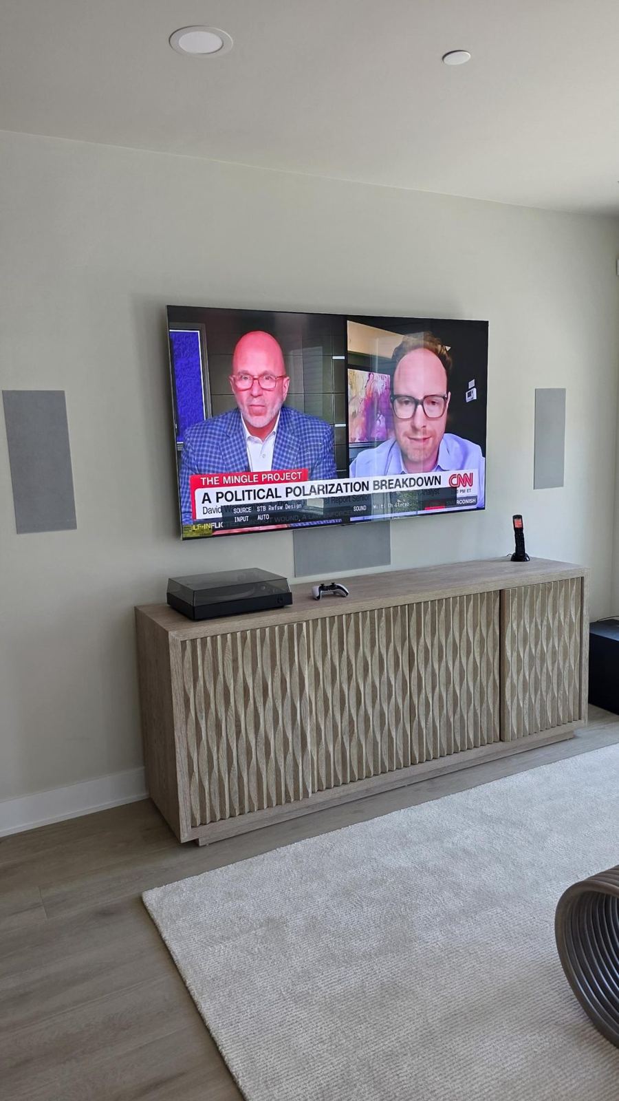 Finished media wall with TV over a low credenza