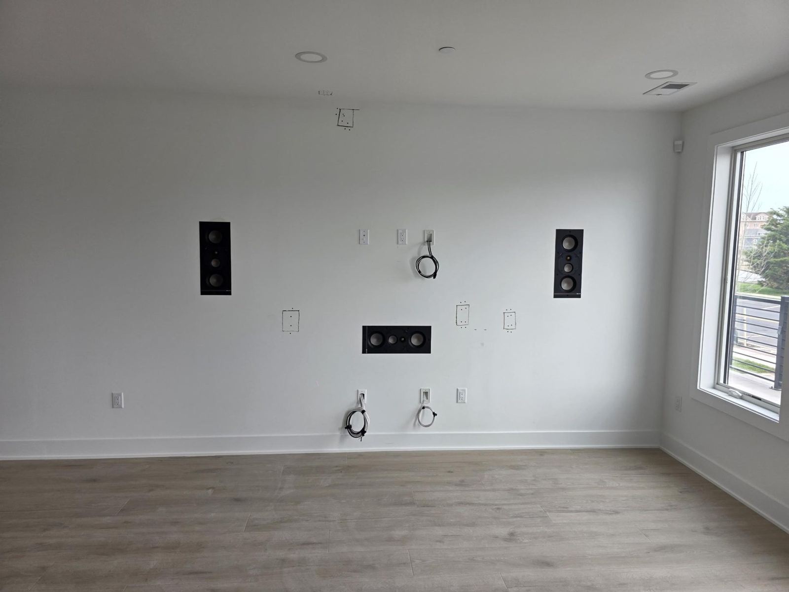 In-wall speakers and low-voltage plates set before the display