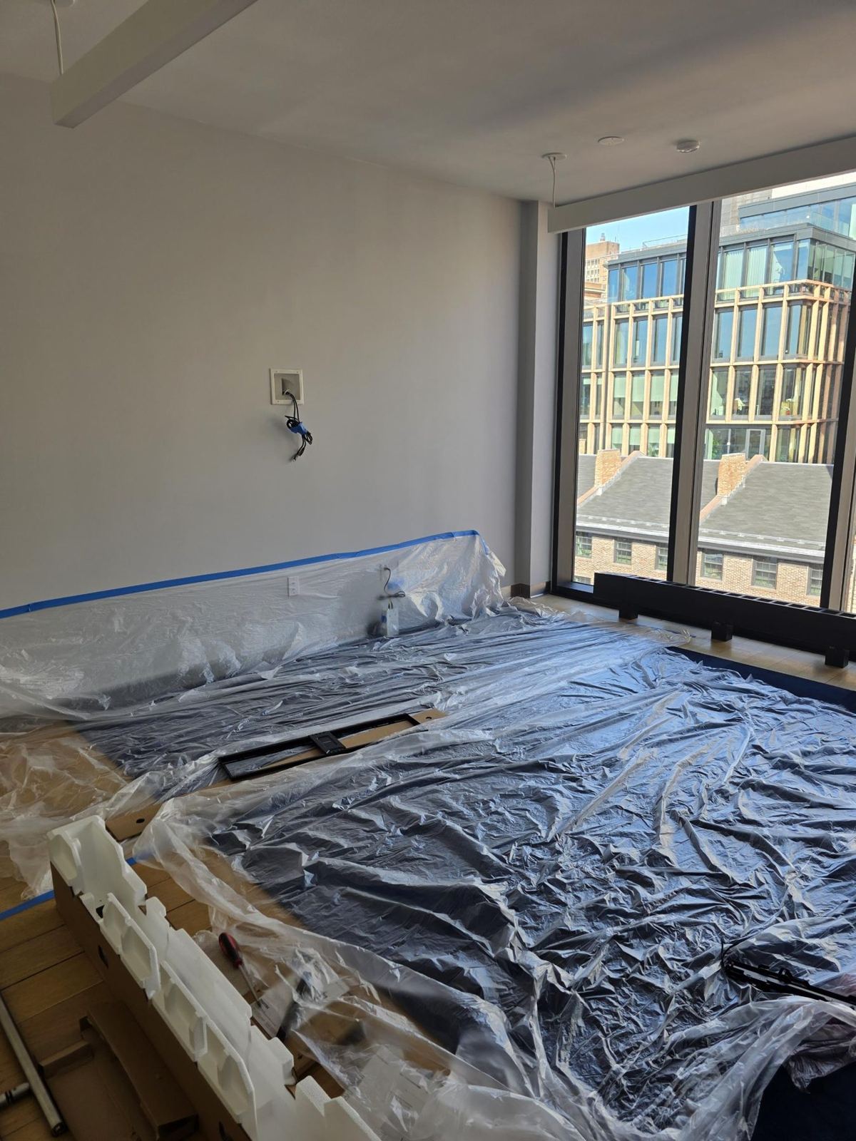 Bedroom floor covered in protection during finish work