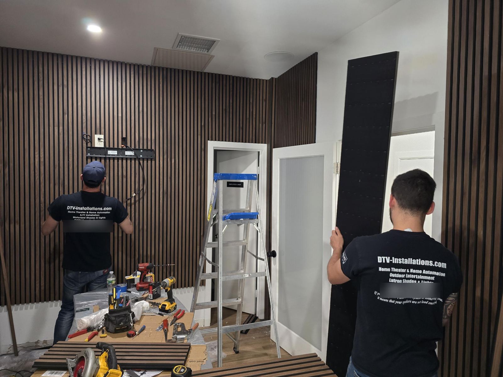 Crew installing a wood slat wall and TV mount