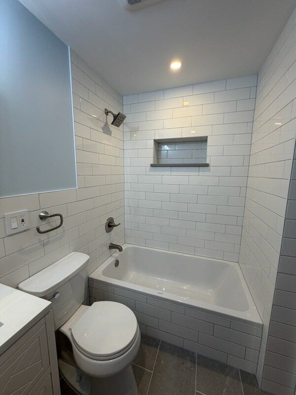 Subway tile tub surround with brushed nickel fixtures